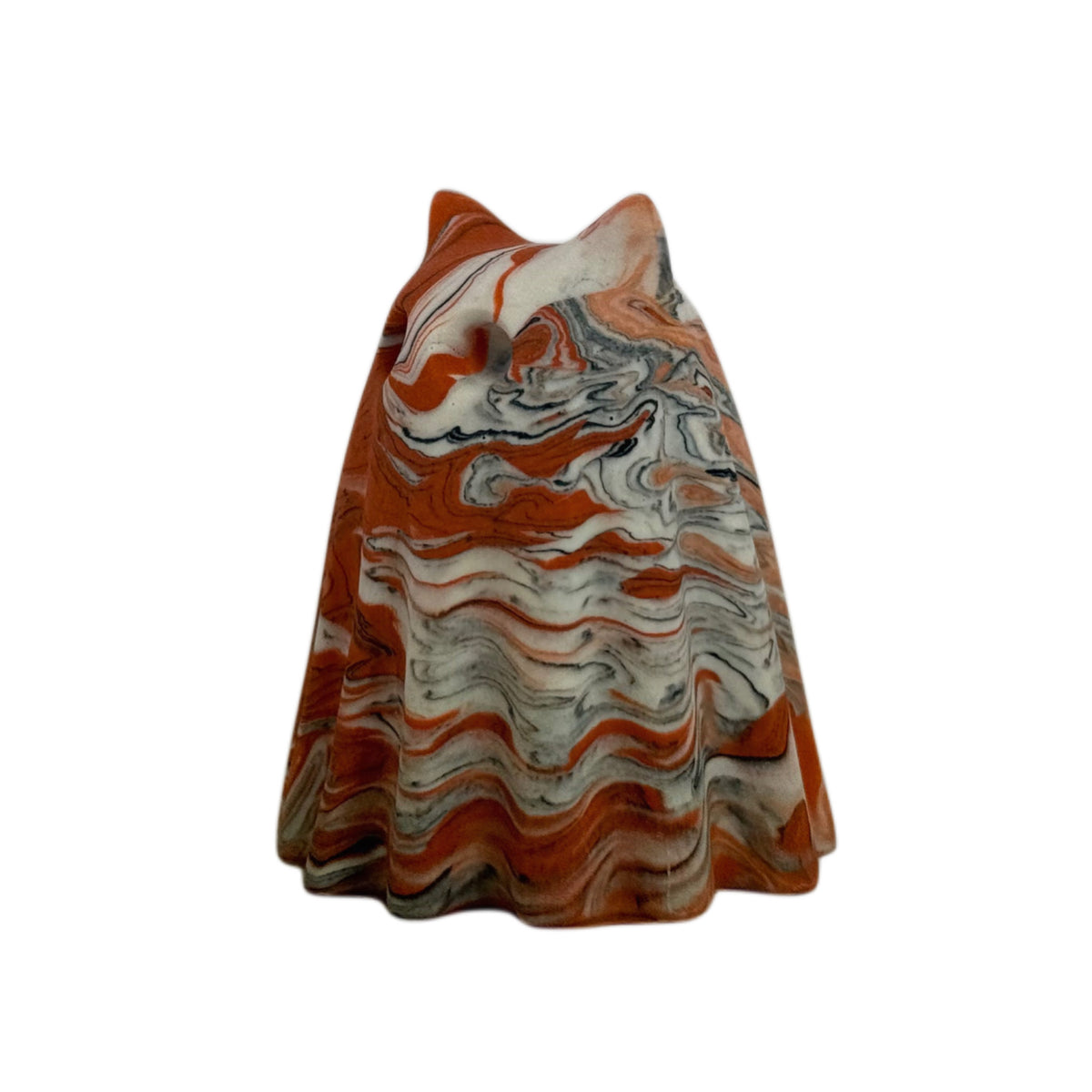 Crumble Windfall ghost figurine, angled side view showing layered orange and cream marbling with fine charcoal veining across the face and body.