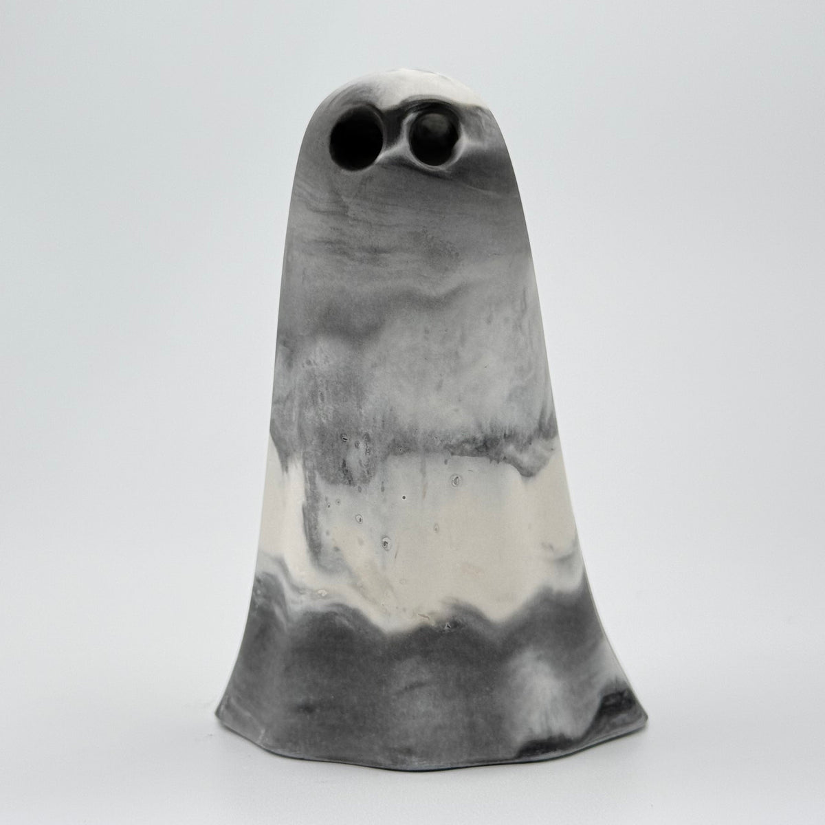 A grey and white smoky handmade ghost figurine made by The Nordic Ghost Merchants. Front view