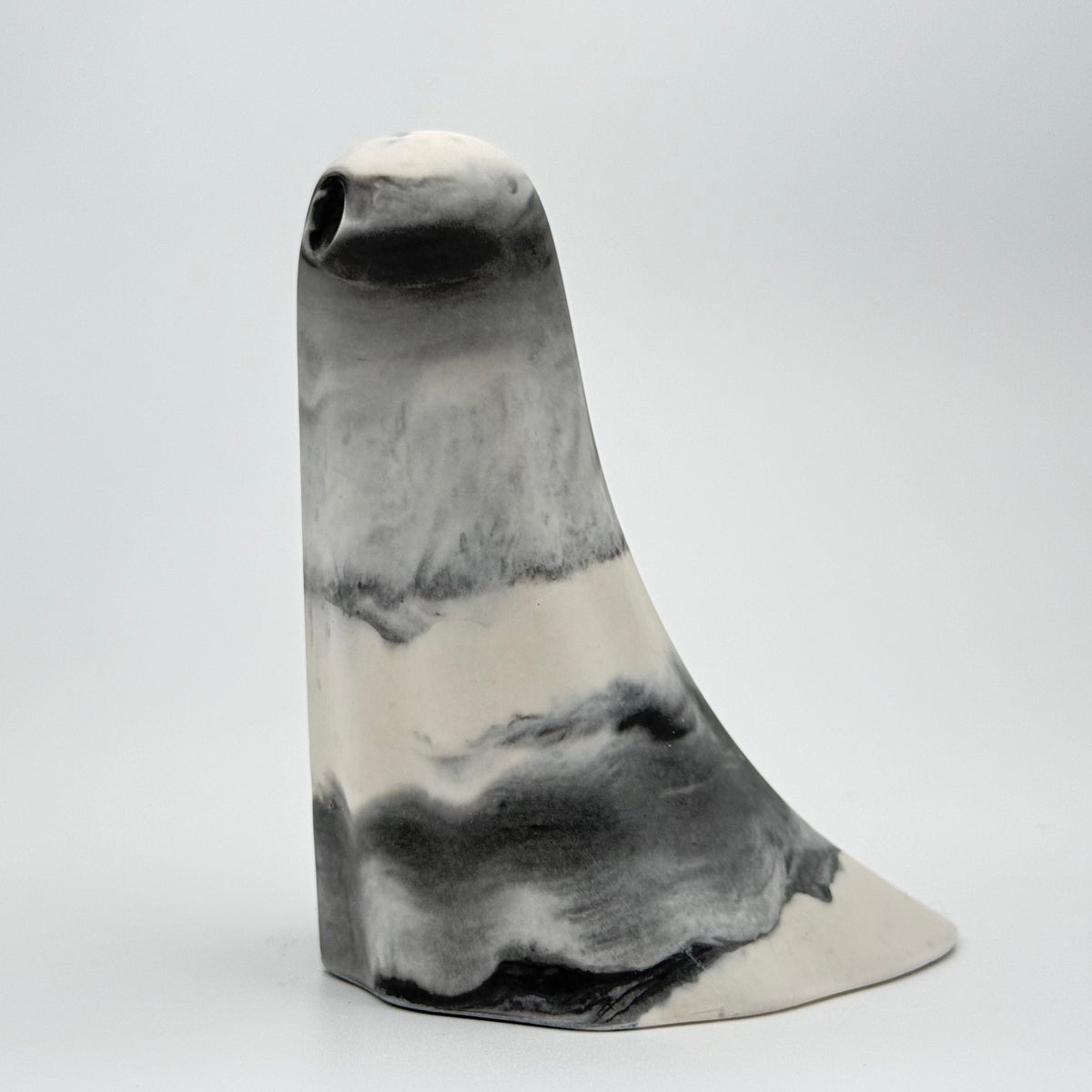 A grey and white smoky handmade ghost figurine made by The Nordic Ghost Merchants. Side view