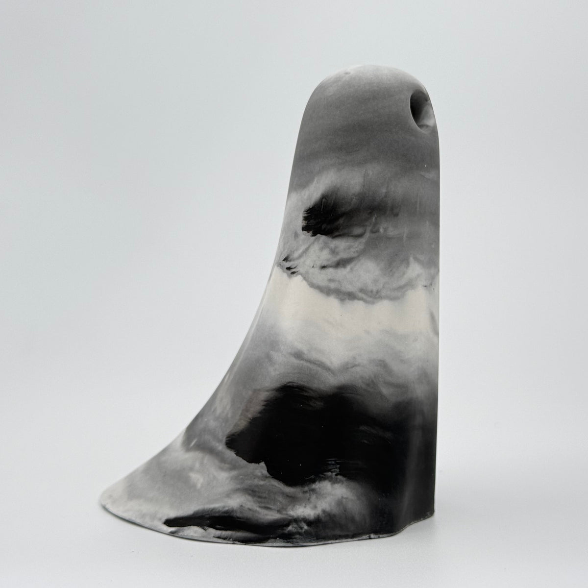 A grey and white smoky coloured ghost figurine made by The Nordic Ghost Merchants. Side view