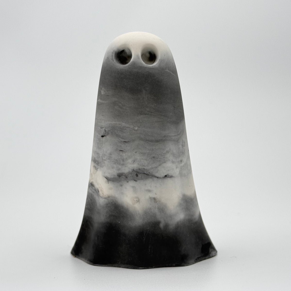 A grey and white smoky ghost figurine handmade by The Nordic Ghost Merchants. Front view
