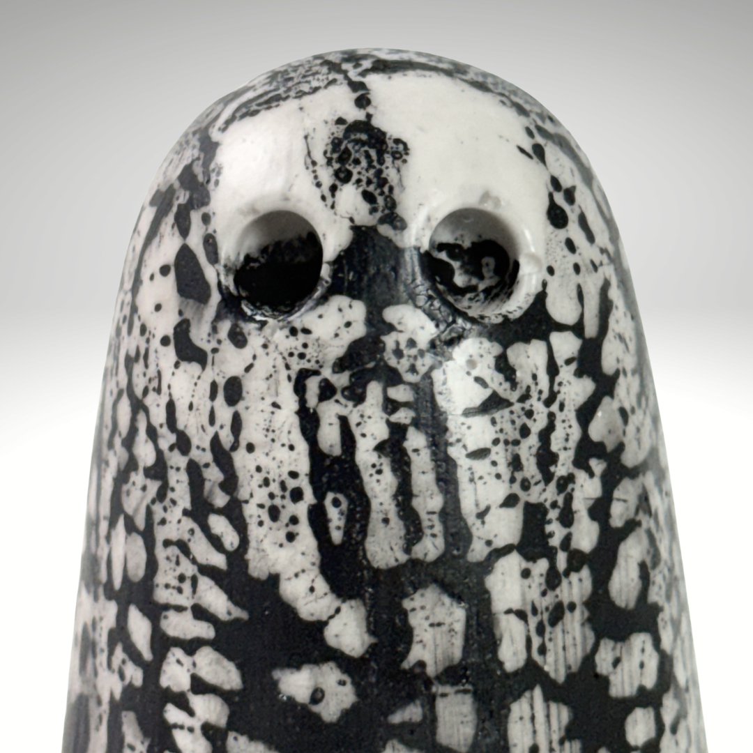 A close up of the face of a white and black handmade ghost figurine from The Nordic Ghost Merchants.