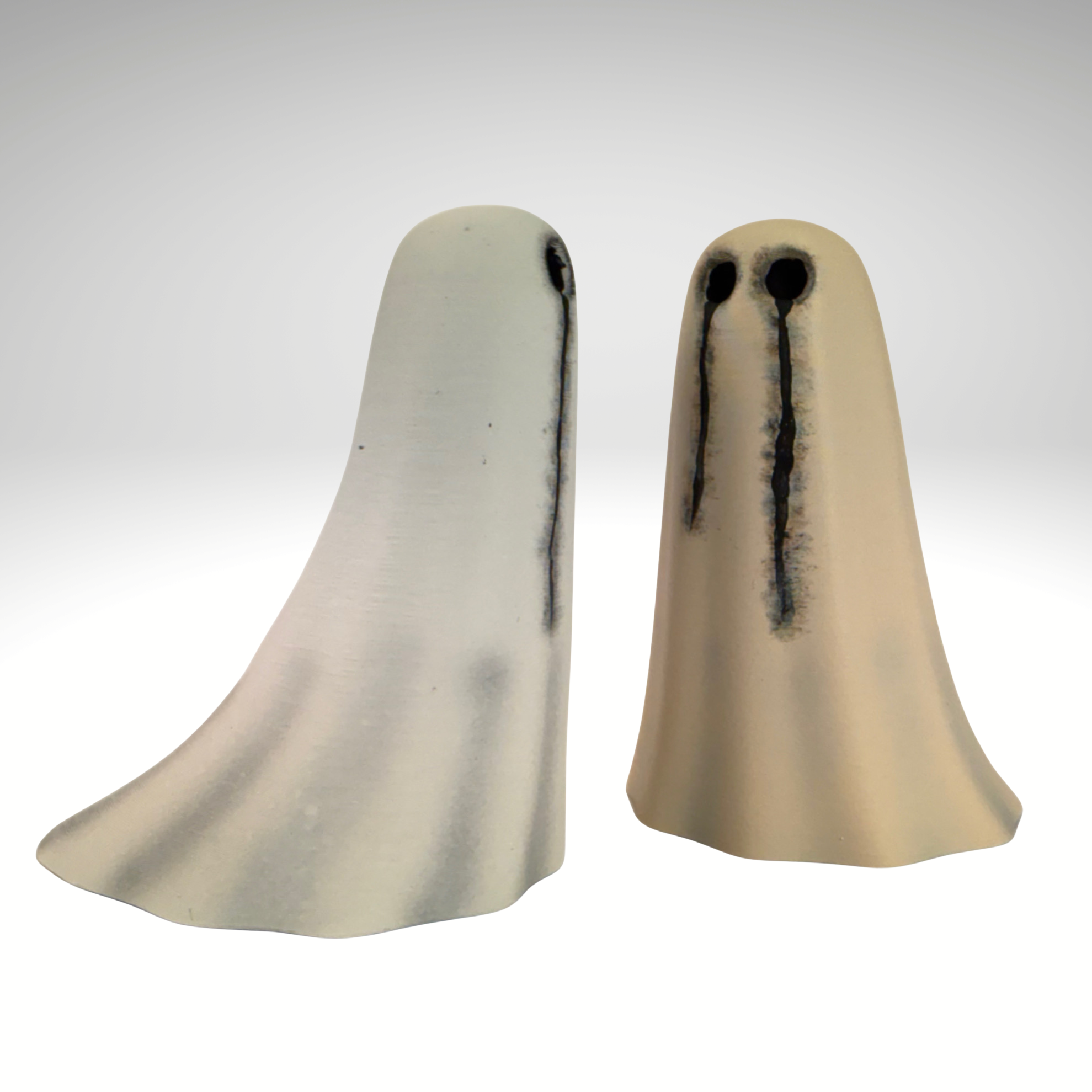 Two collectible ghost figurines in ivory and bone white from The Nordic Ghost Merchants