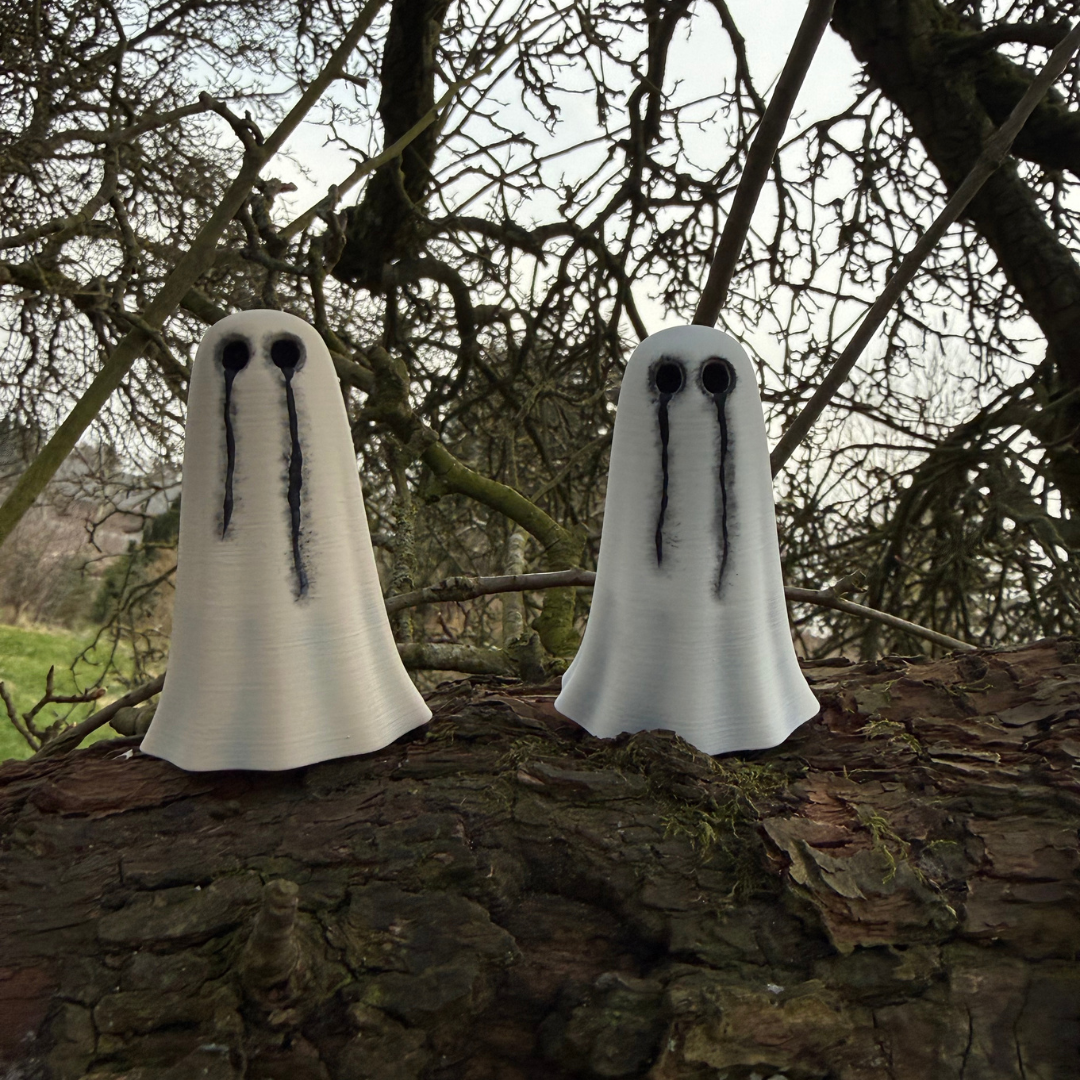Two ghost figurines by The Nordic Ghost Merchants, sitting in an old, gnarled tree