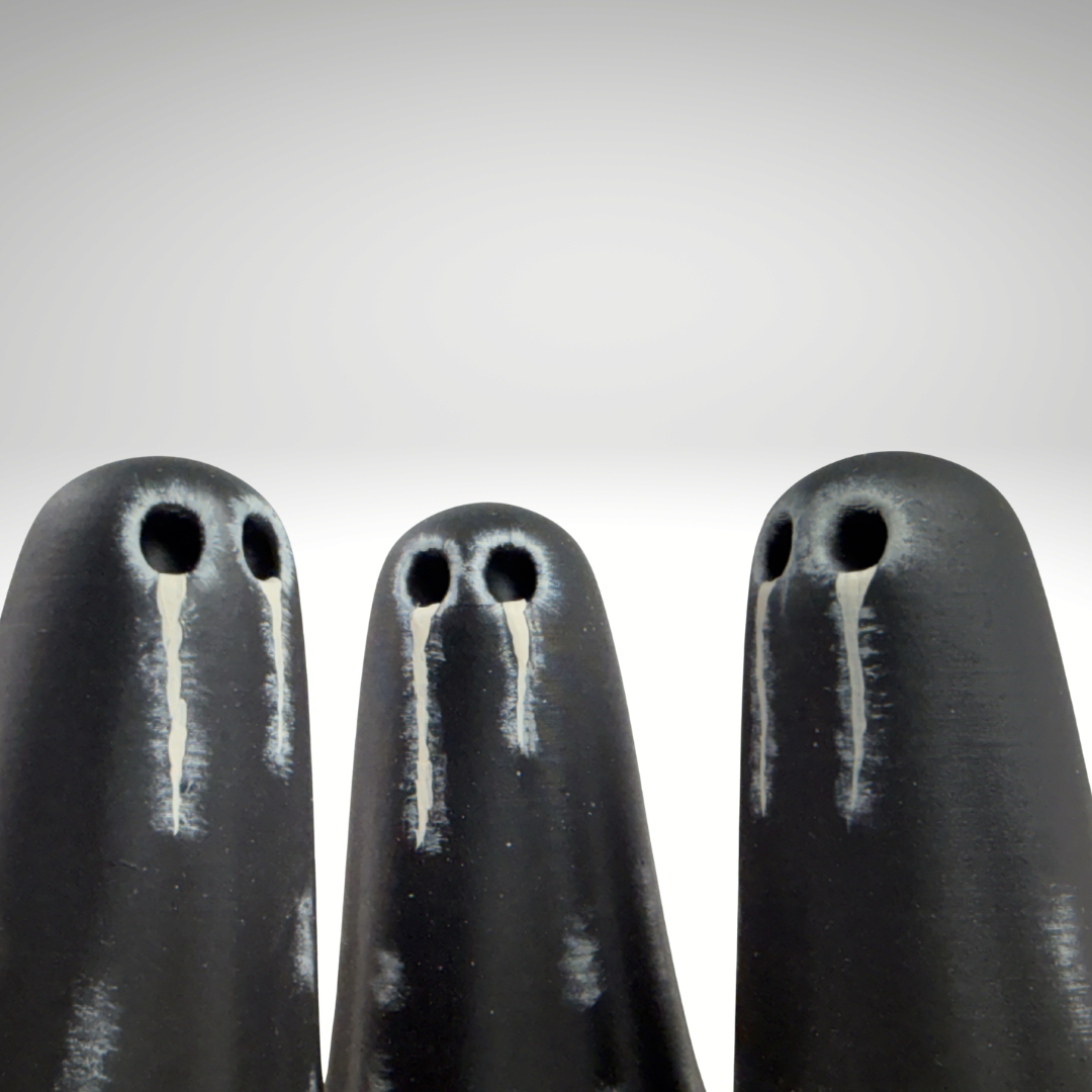 Black ghost figurines with ivory teary eye details made by The Nordic Ghost Merchants