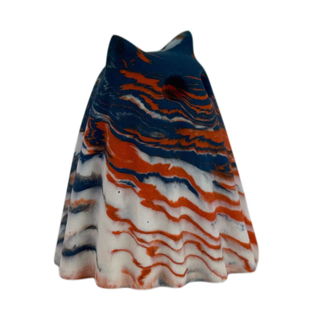 Crispin Windfall Familiar ghost figurine, angled side view showing a deep blue crown with burnt orange and cream marbling flowing through the body.
