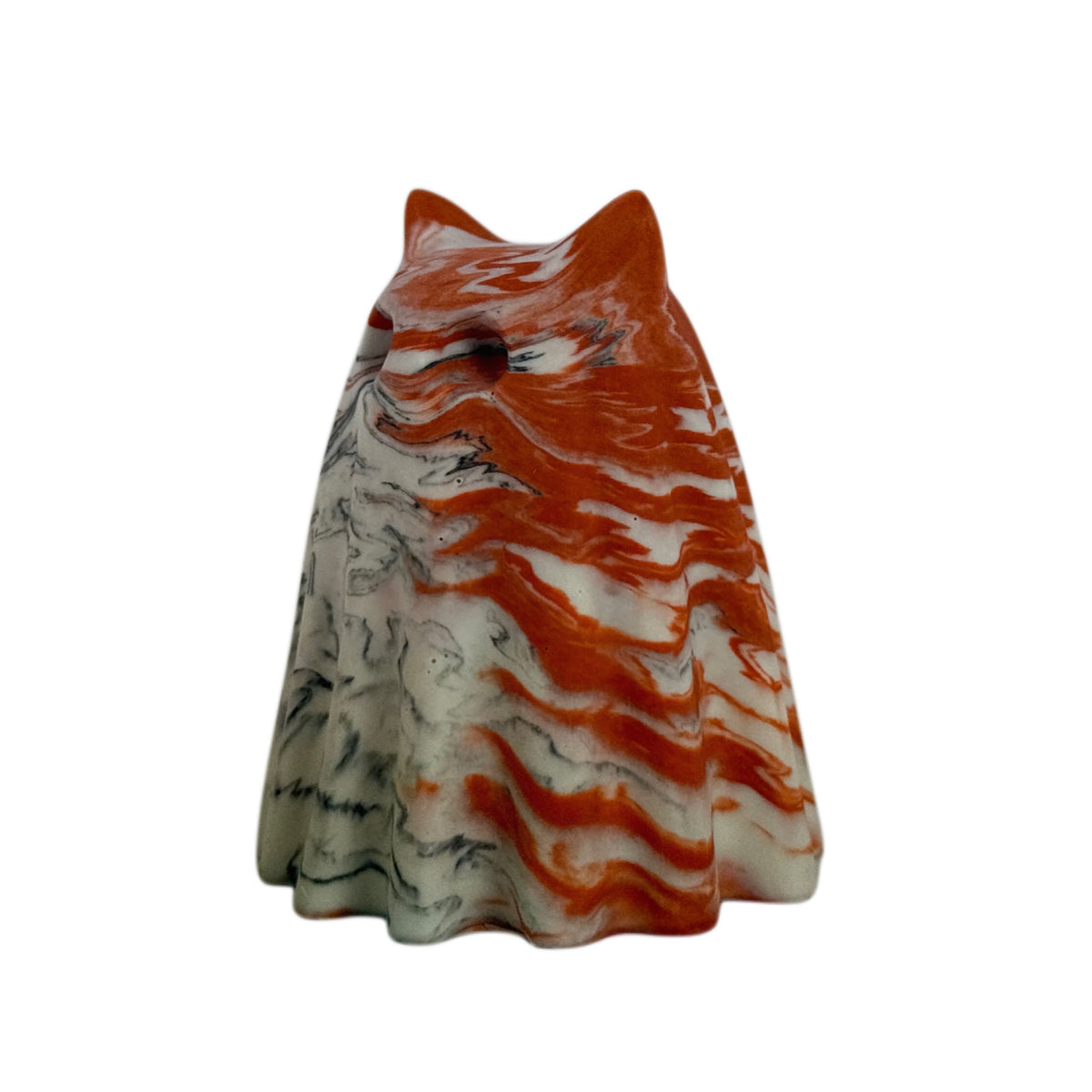 Bojangles Windfall ghost cat figurine, angled side view showing vivid burnt orange marbling across the head and right side with soft cream and charcoal swirls.