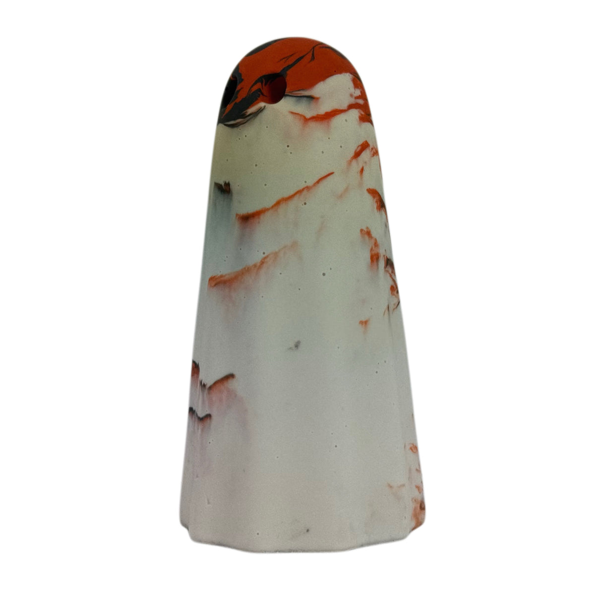 Ossrik Windfall Ghost figurine, angled side view showing a pale cream body with burnt orange and charcoal-black marbling concentrated around the crown.