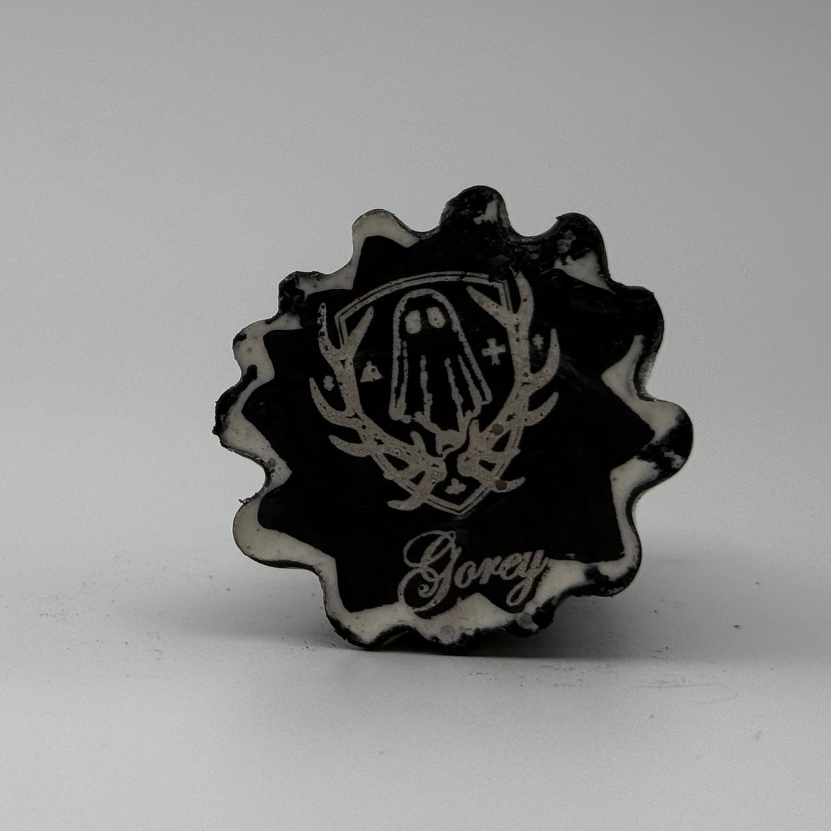 A small white and grey ghost at figurine made by The Nordic Ghost Merchants. Base view