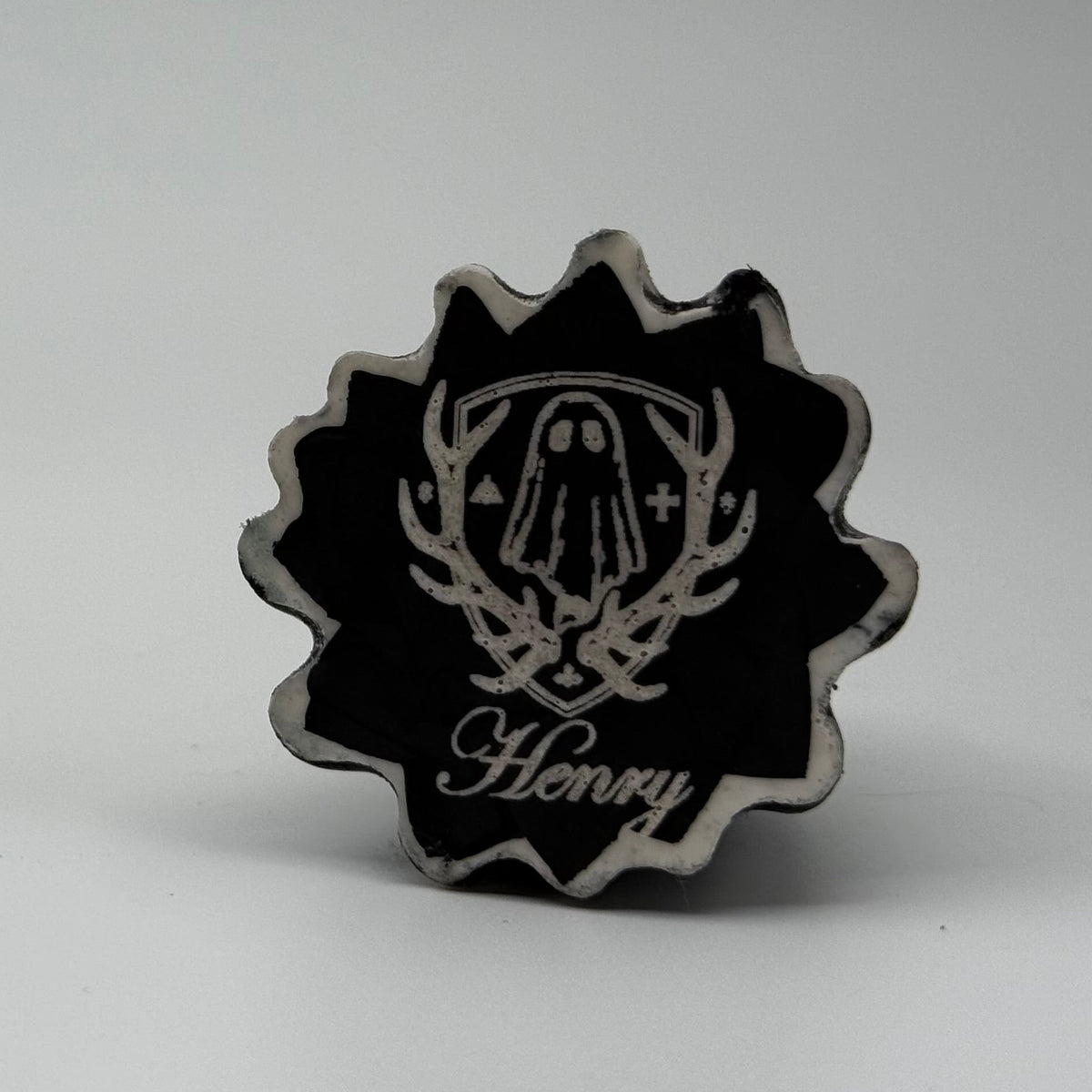 A small black and white ghost cat figurine handmade by The Nordic Ghost Merchants. The pattern resembles rain running down a window. Base view
