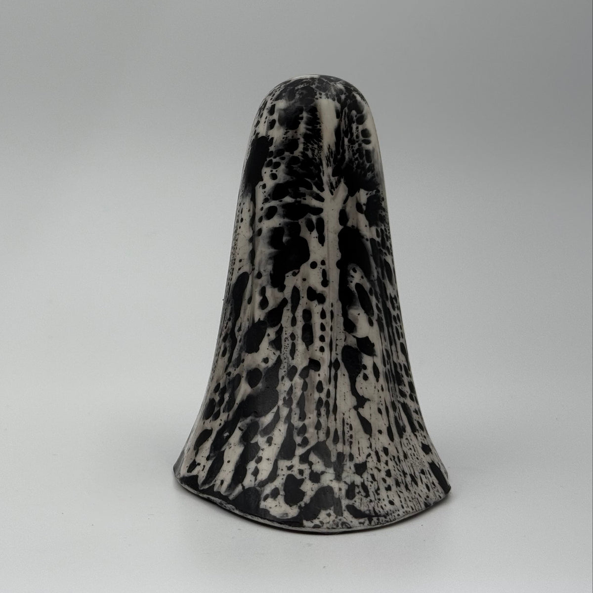 An ivory ghost figurine with black, bark like patterning, made by The Nordic Ghost Merchants. Rear view. 