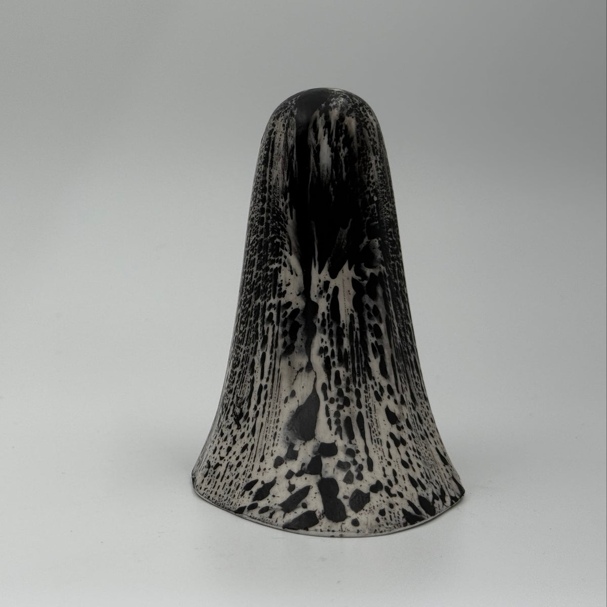 An ivory ghost figurine with black bark like patterning made by The Nordic Ghost Merchants. Rear view.