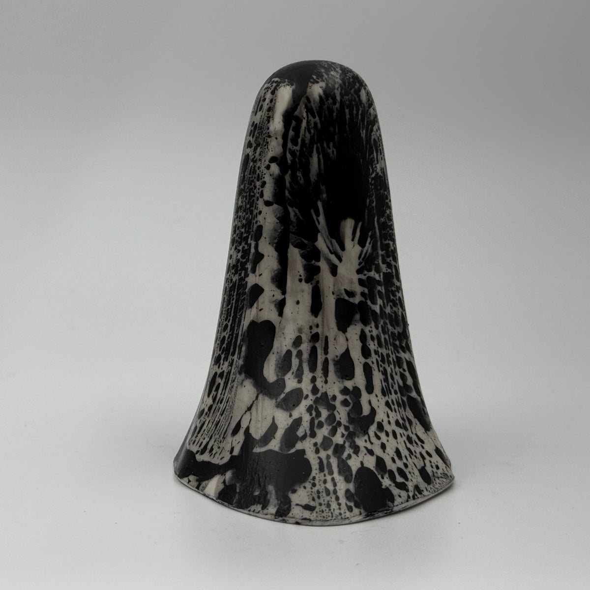 An ivory ghost figurine with black, bark like patterning made by The Nordic Ghost Merchants. Rear view