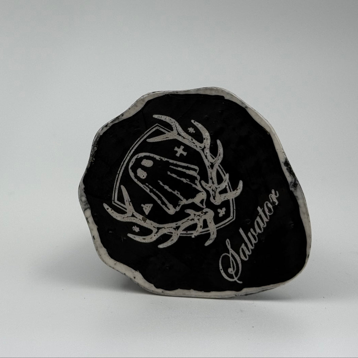 An ivory ghost figurine with black, bark like patterning made by The Nordic Ghost Merchants. Baseview