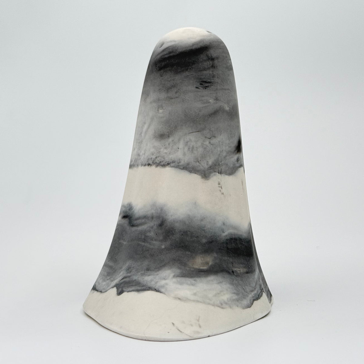 A grey and white smoky handmade ghost figurine made by The Nordic Ghost Merchants. Rear view