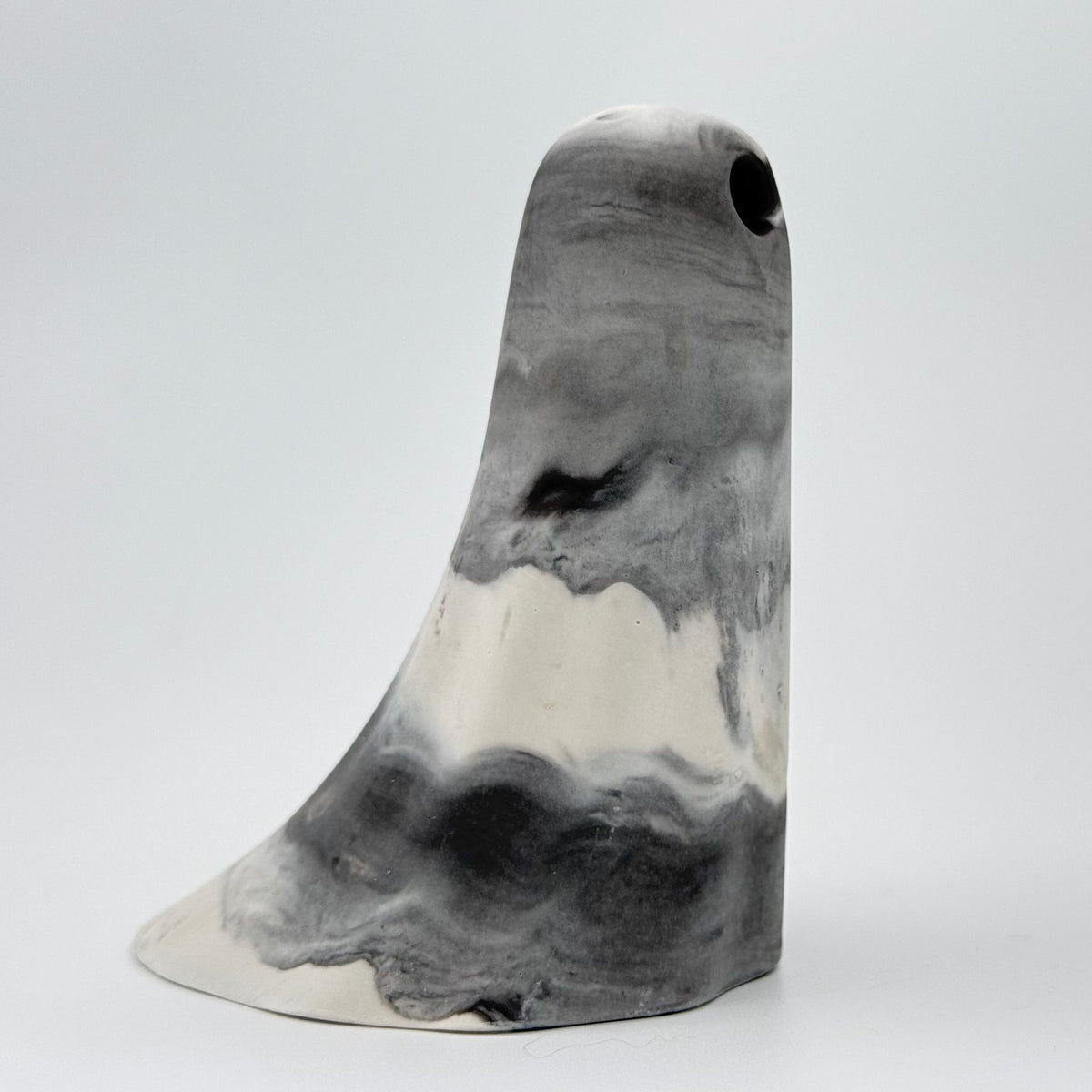 A grey and white smoky handmade ghost figurine made by The Nordic Ghost Merchants. Side view