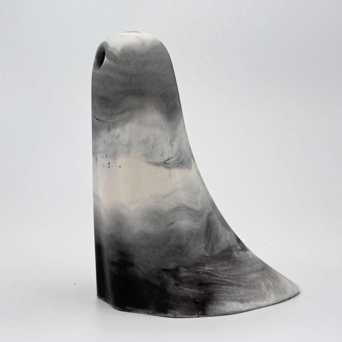 A grey and white smoky coloured ghost figurine made by The Nordic Ghost Merchants. Side view