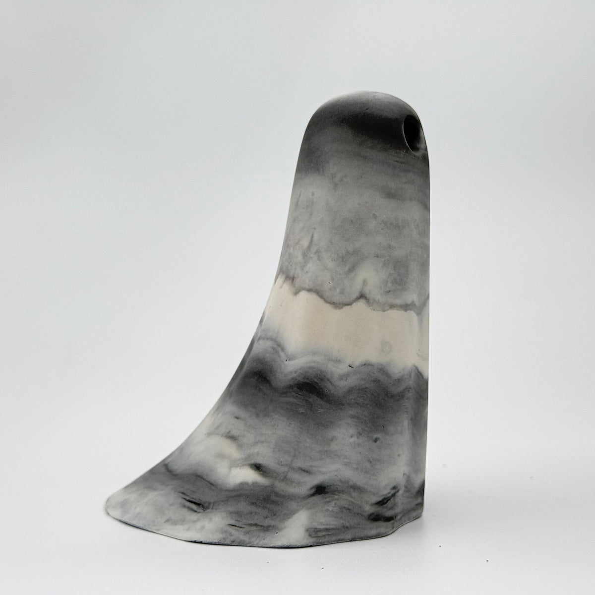 A grey and white marbled ghost figurine, handmade by The Nordic Ghost Merchants. Side view