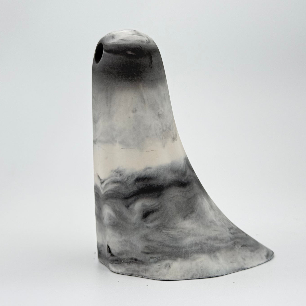 A grey and white marbled ghost figurine, handmade by The Nordic Ghost Merchants. Side view