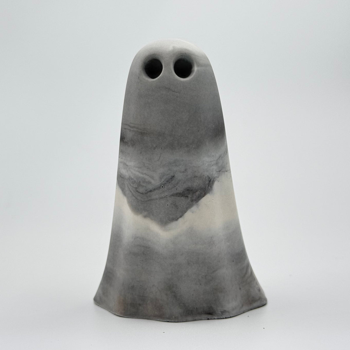 A handmade ghost figurine in swirling shades of grey and white, reminiscent of fog, made by The Nordic Ghost Merchants. Front view