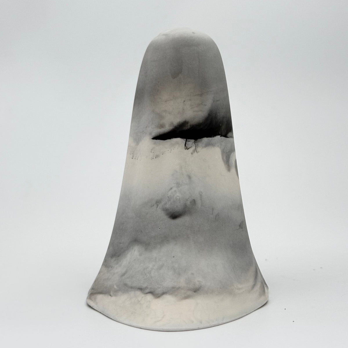 A handmade ghost figurine in swirling shades of grey and white, reminiscent of fog, made by The Nordic Ghost Merchants. Rear view