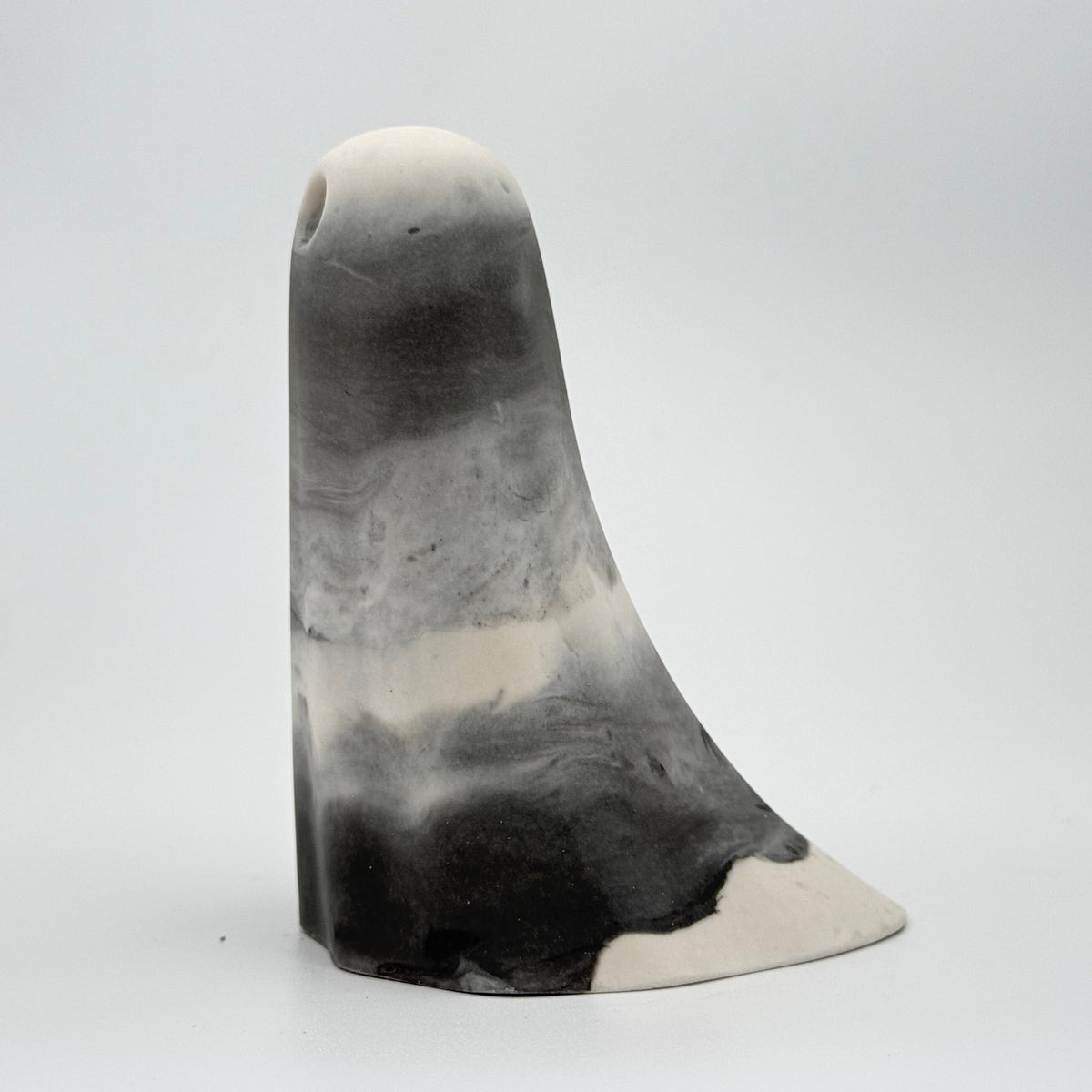 A grey and white smoky ghost figurine handmade by The Nordic Ghost Merchants. Rear view