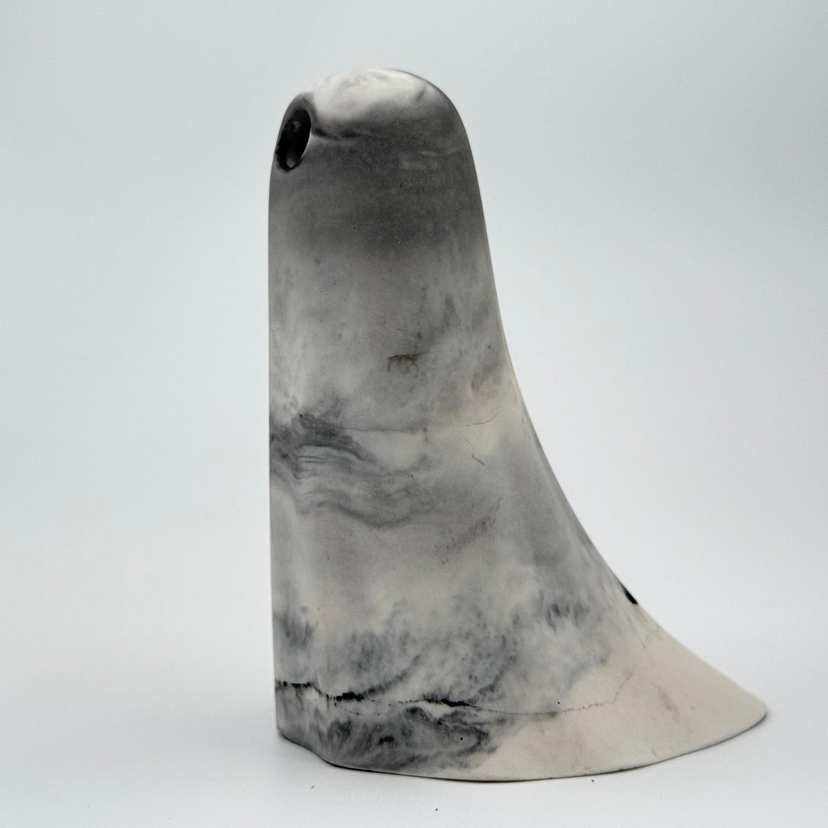 A grey and white smoky handmade ghost figurine by The Nordic Ghost Merchants. Side view